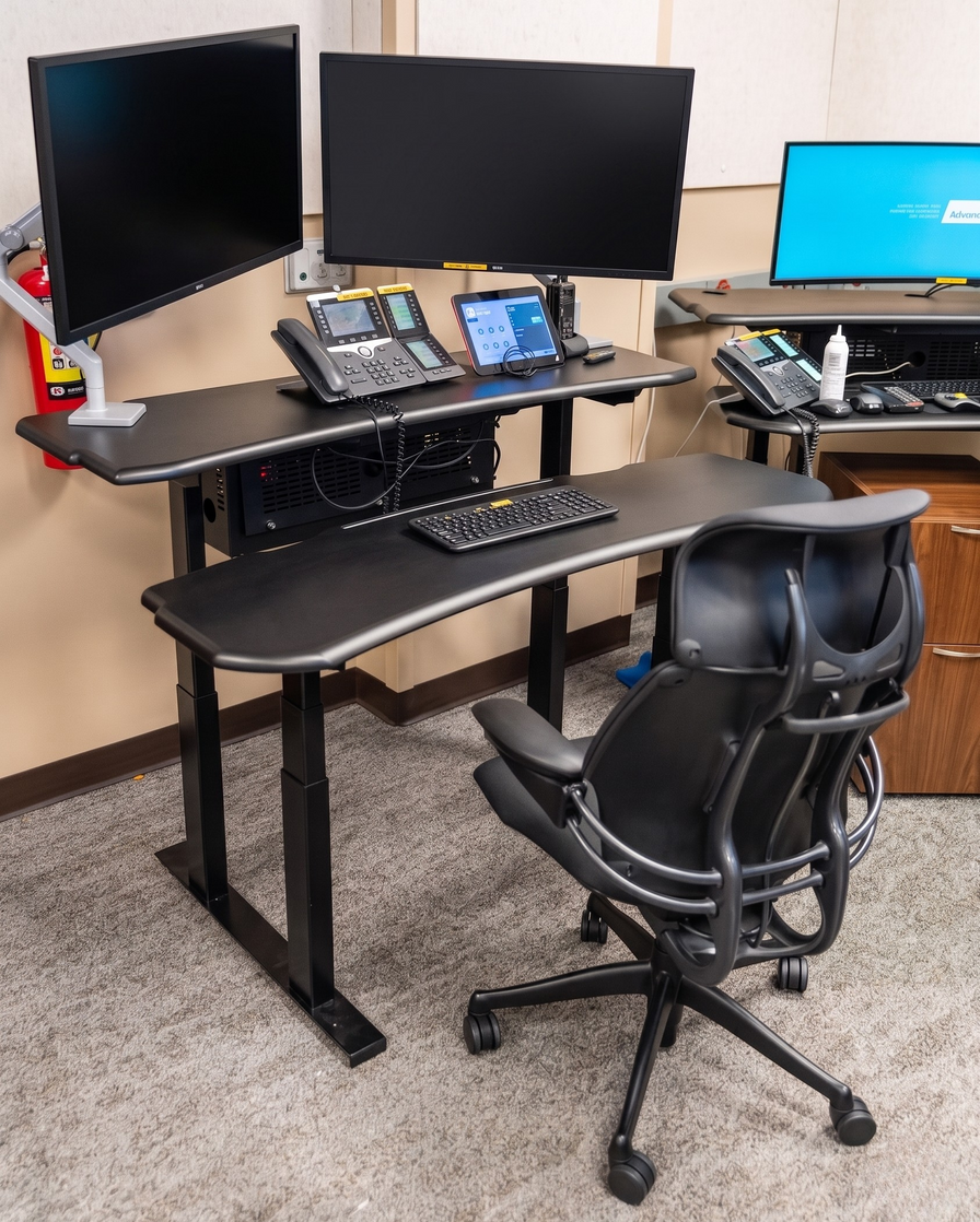 Ergonomic Dual Surface radiology desk setup with multiple computer monitors, a desk, and chair.